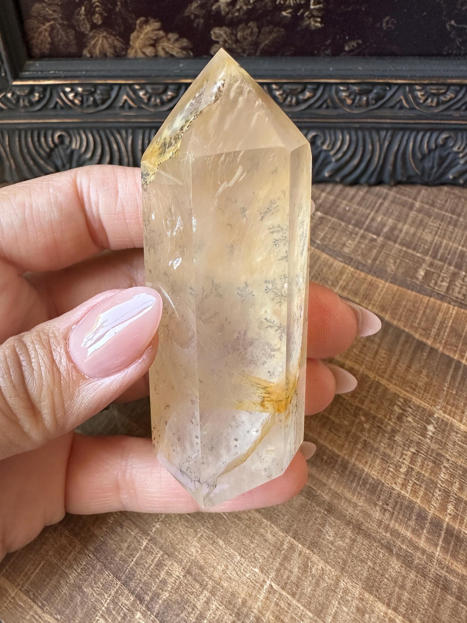 Transparent dendritic quartz tower with golden healer