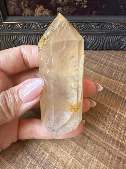 Transparent dendritic quartz tower with golden healer